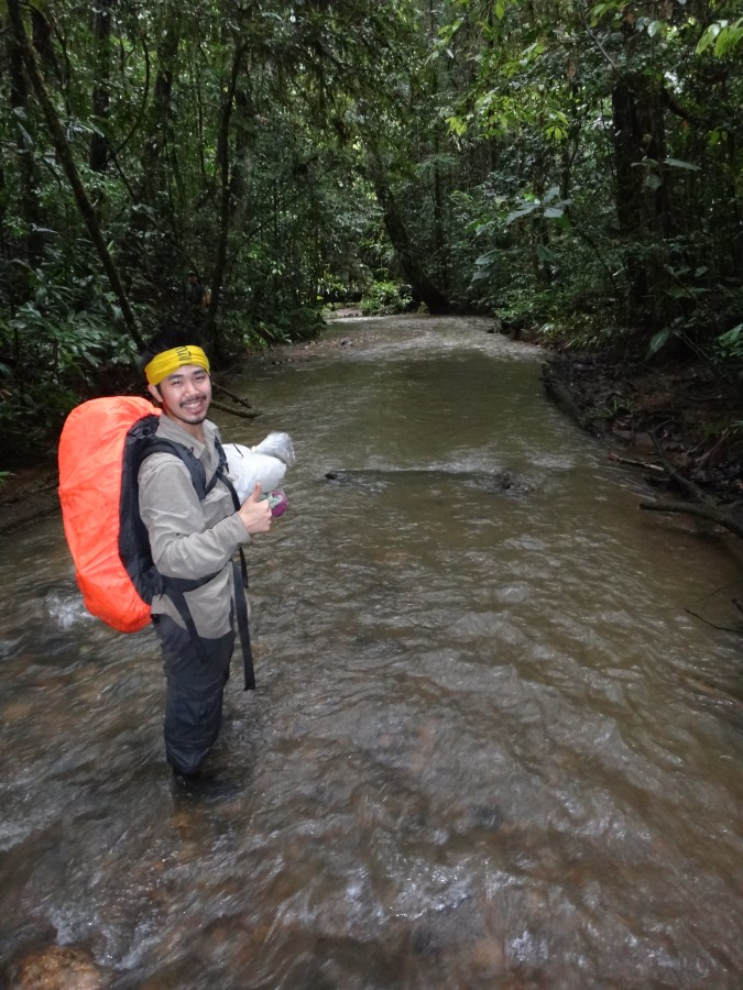 Seth wading through a stream