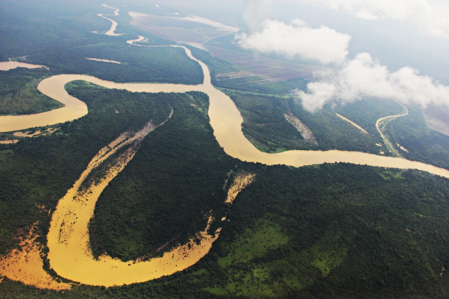 As we leave the forests behind, man's activities begin to appear - plantations in the distance.